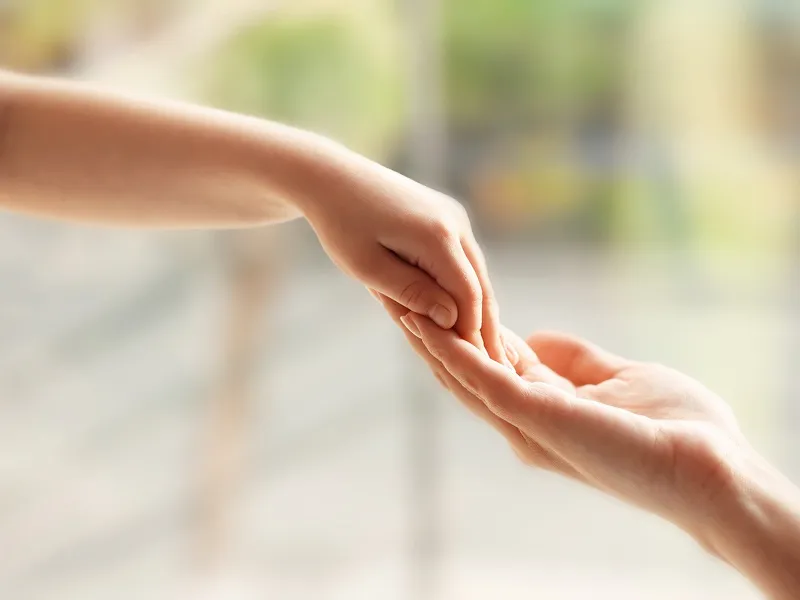 手を繋ぎあっている親子